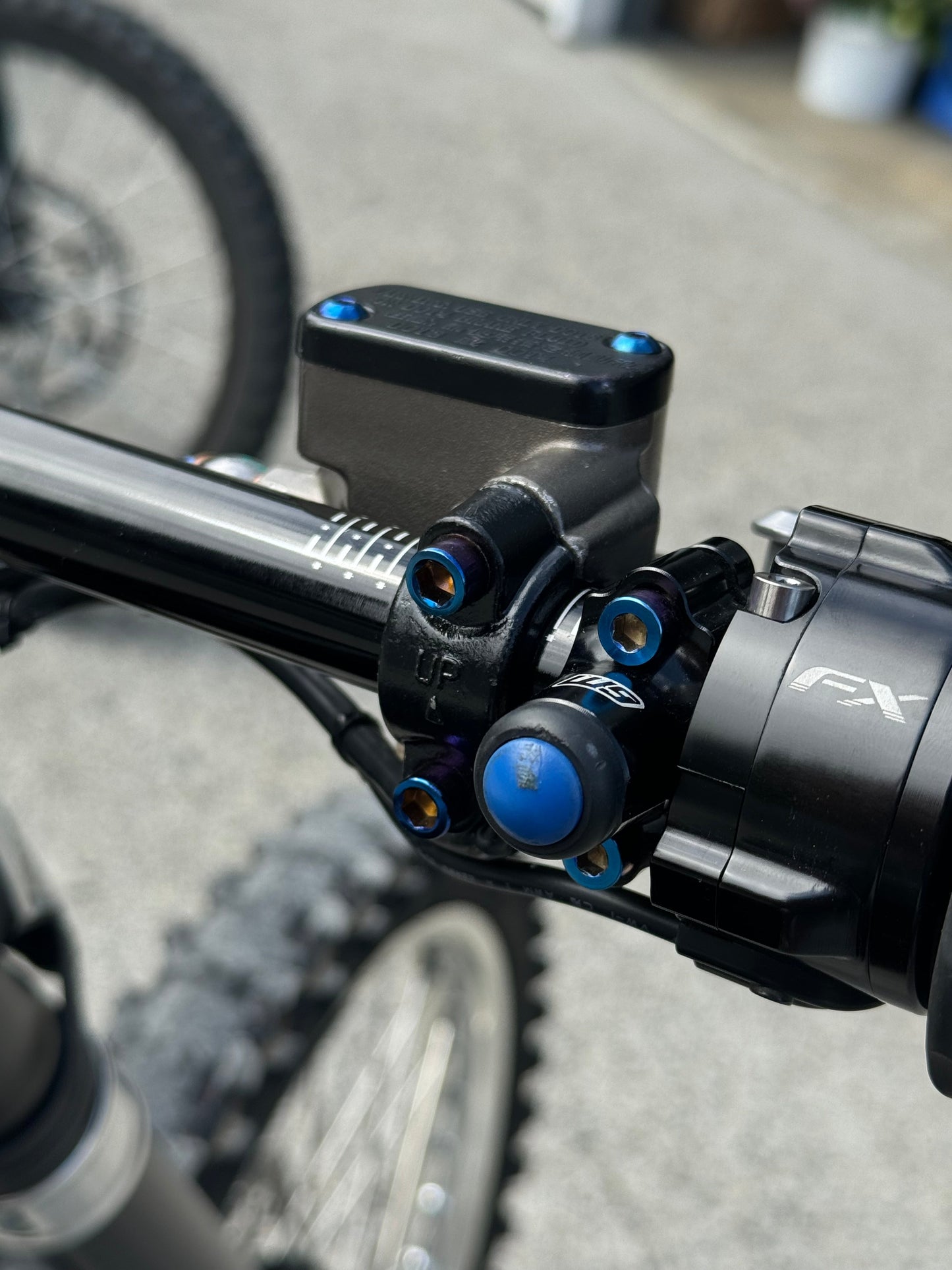 Mxp_designs ultra bee brake mount holder shown in black, mounted on a bike handlebar for secure brake cable management.
