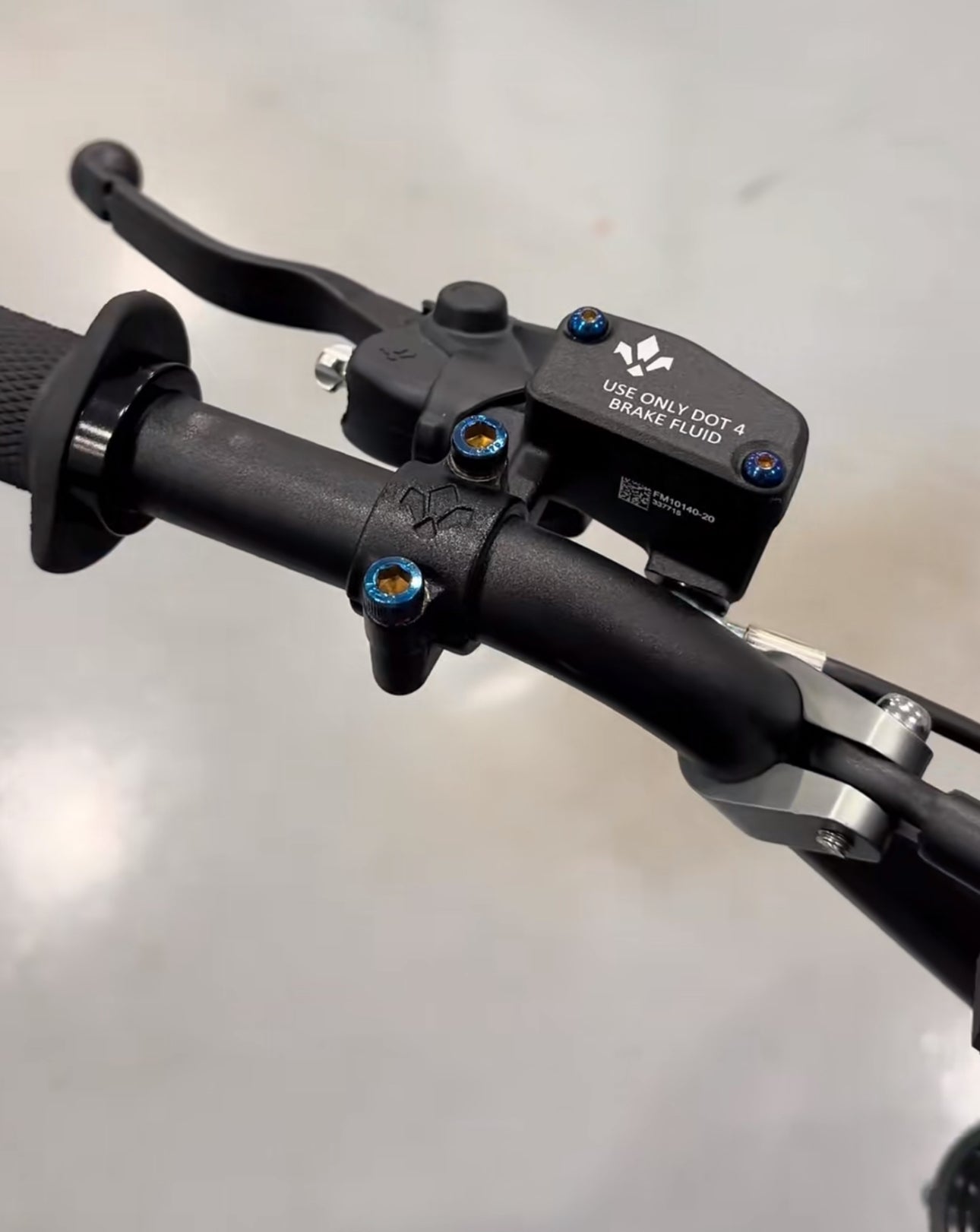 Titanium brake reservoir bolts by Mxp_designs showing shiny, durable fasteners installed on motorcycle brake system.