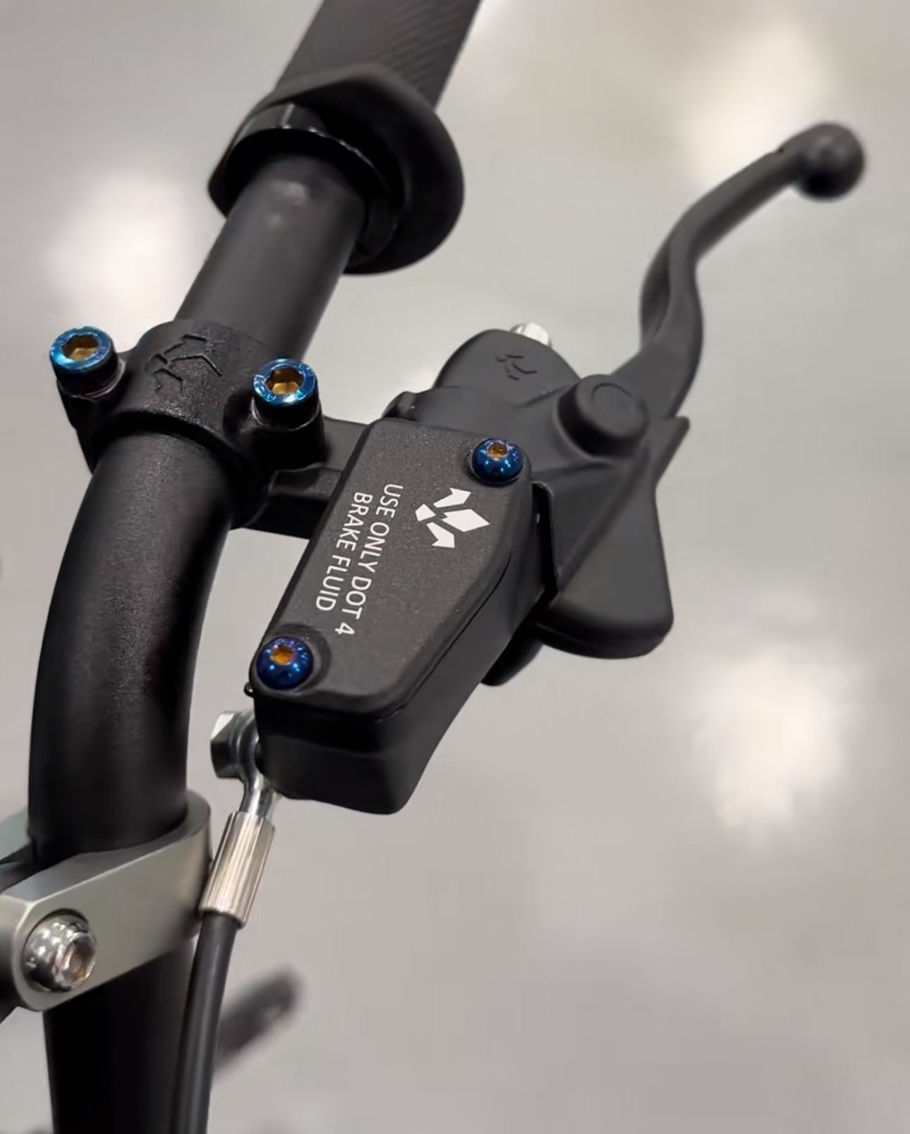 Titanium brake reservoir bolts by Mxp_designs, showing close-up of sleek, lightweight, corrosion-resistant fasteners for motorcycle braking system