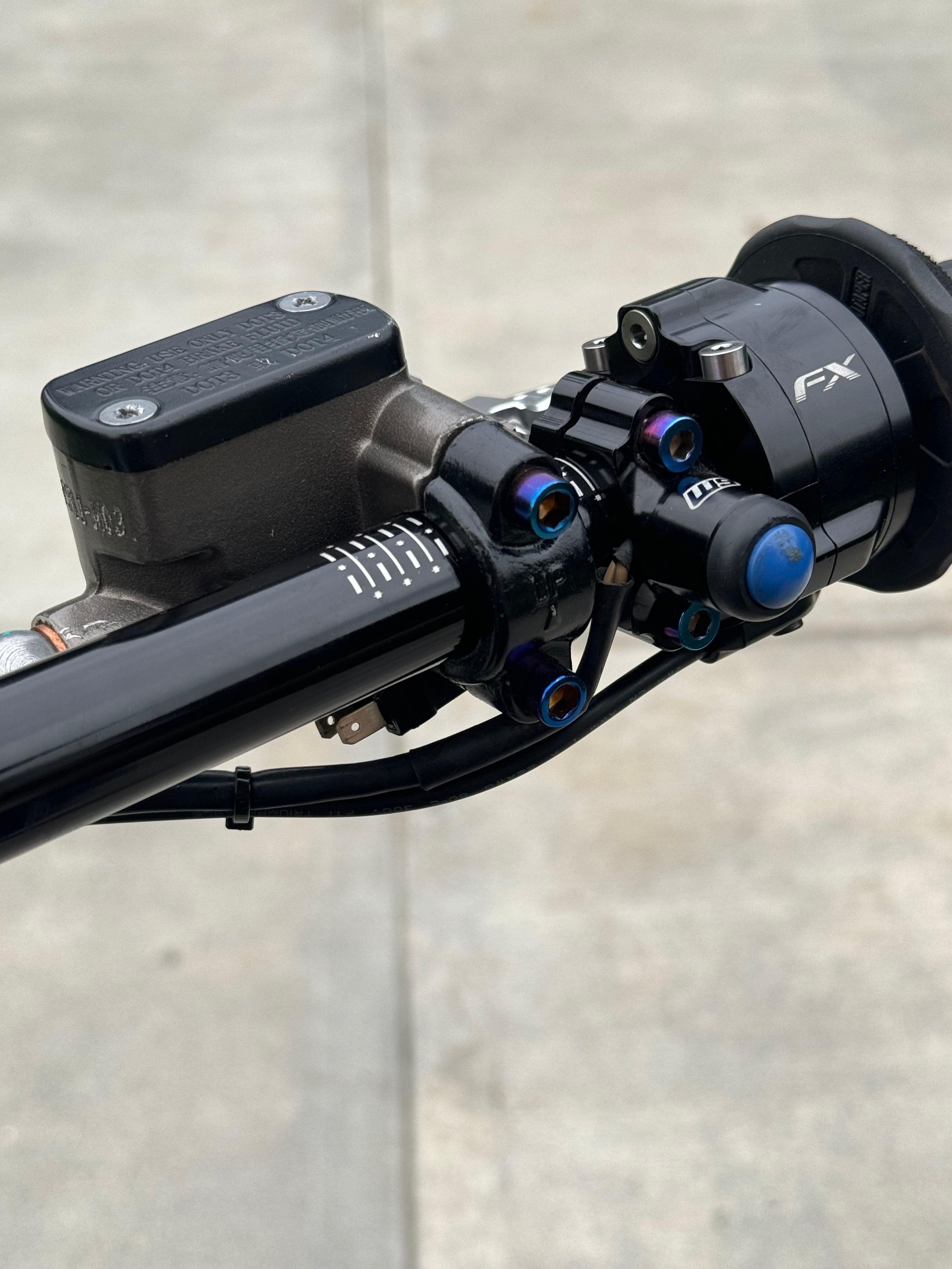 Titanium brake mount bolts by Mxp_designs, showing shiny, durable fasteners designed for high-performance bicycle brake systems.