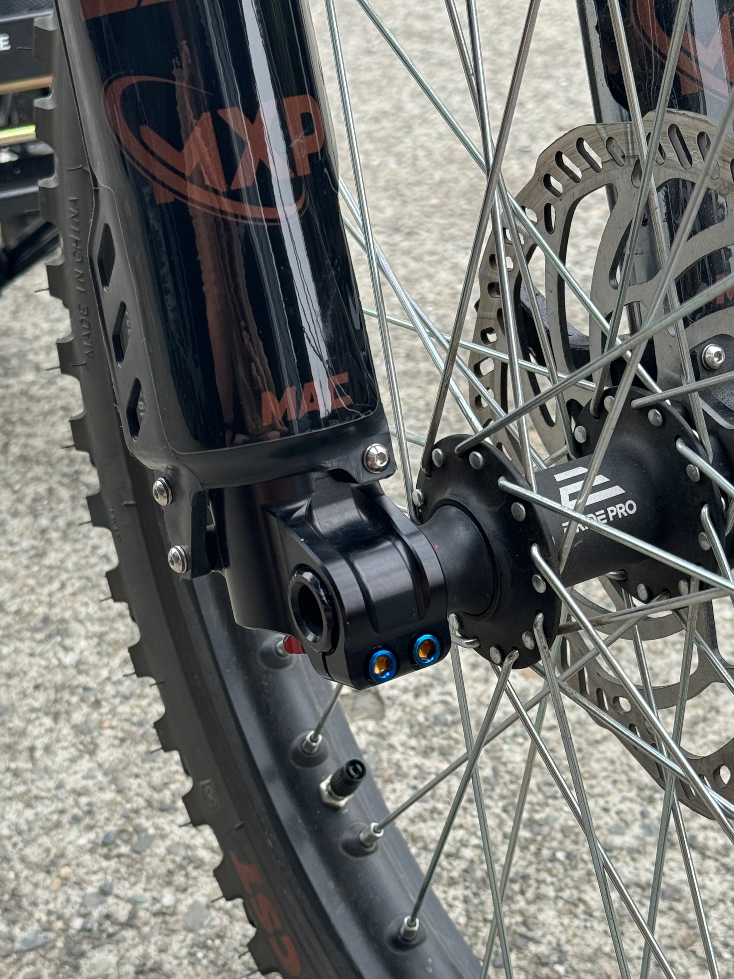 Mxp_designs titanium fork bolts with a sleek, polished finish, designed for durable and lightweight bike component assembly.