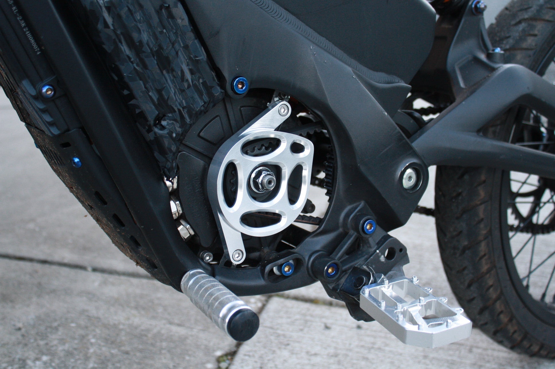 Mxp_designs Talaria XXX motor cover fitted over a motorcycle engine, showcasing protective fabric with branding details.