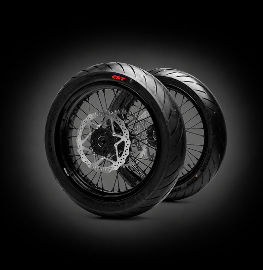Cltridez Ultra Bee Supermoto Wheelset with black rims and spokes, mounted on a motorcycle wheel for high-performance riding.