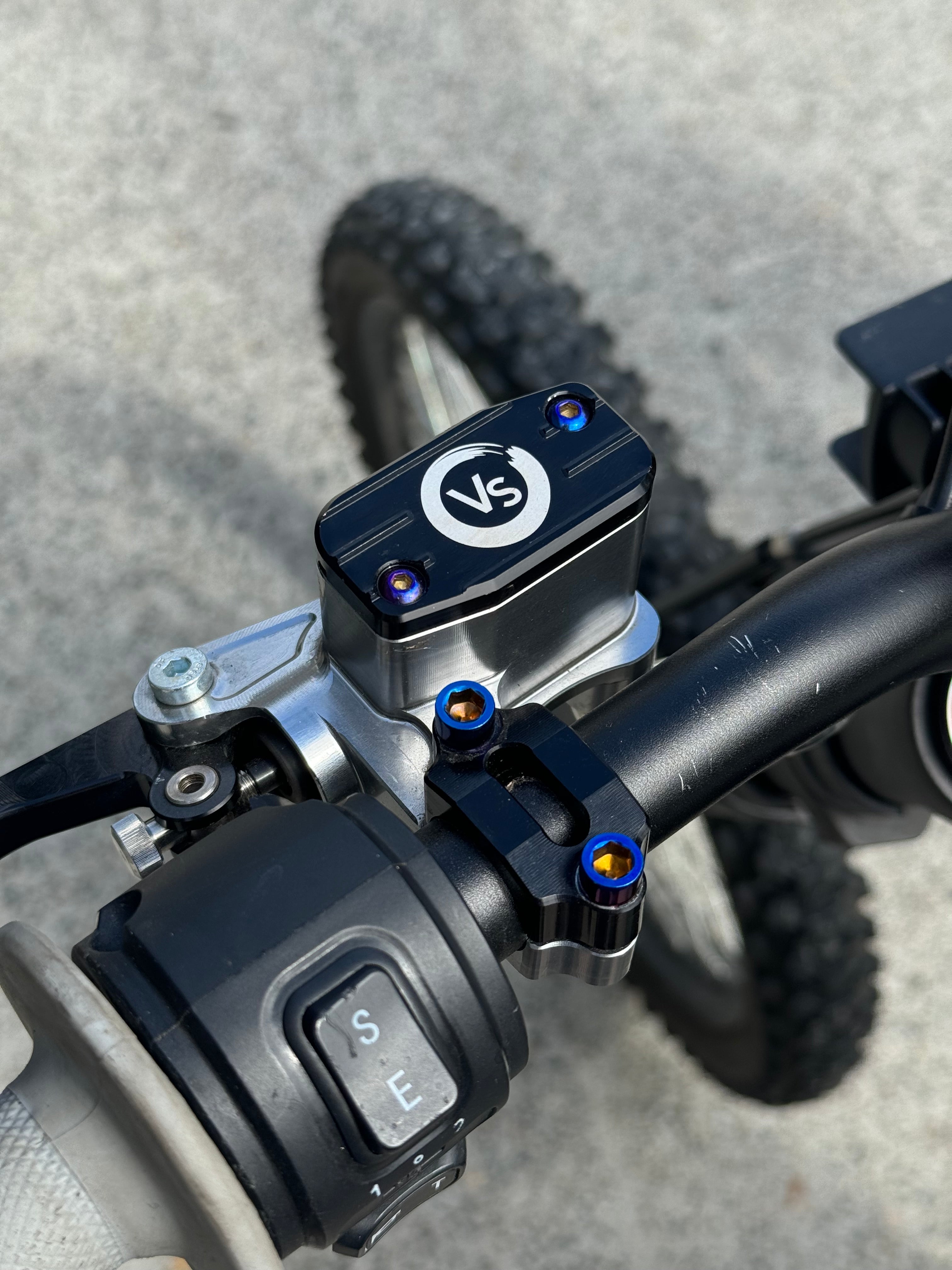 Titanium brake reservoir cap bolts by Mxp_designs, showing a close-up of shiny, durable fasteners for motorcycle brake systems.