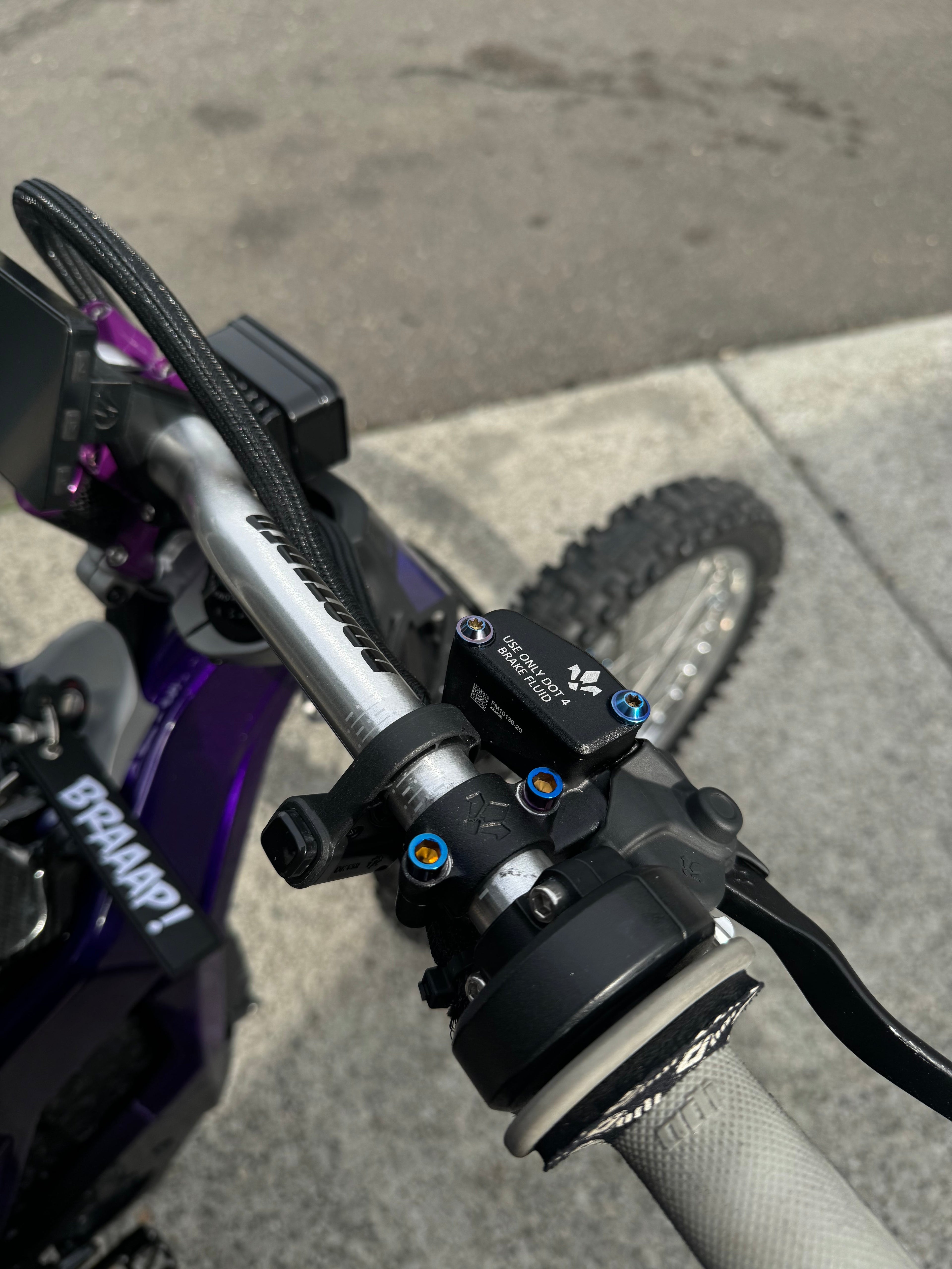 Mxp_designs Formula titanium brake mount bolts installed on a bicycle for lightweight, durable braking system components.
