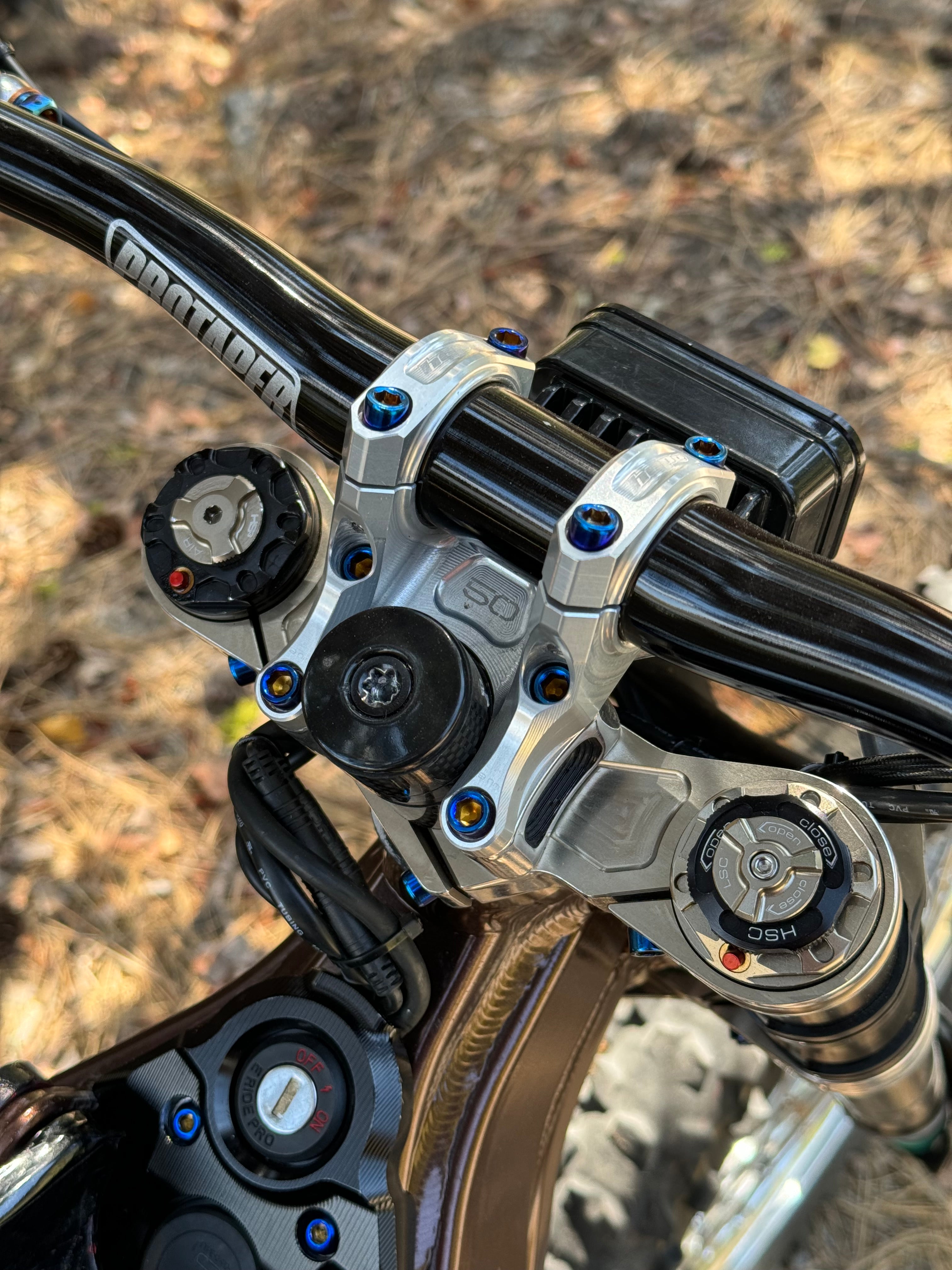 Mxp_designs direct stem riser mount bolts for bicycle handlebars, showing close-up of shiny metal bolts on a bike stem.