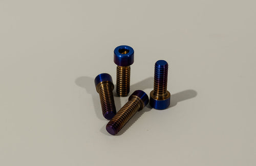 Titanium brake mount bolts from Mxp_designs, showing close-up of durable, lightweight fasteners for bike brake systems.