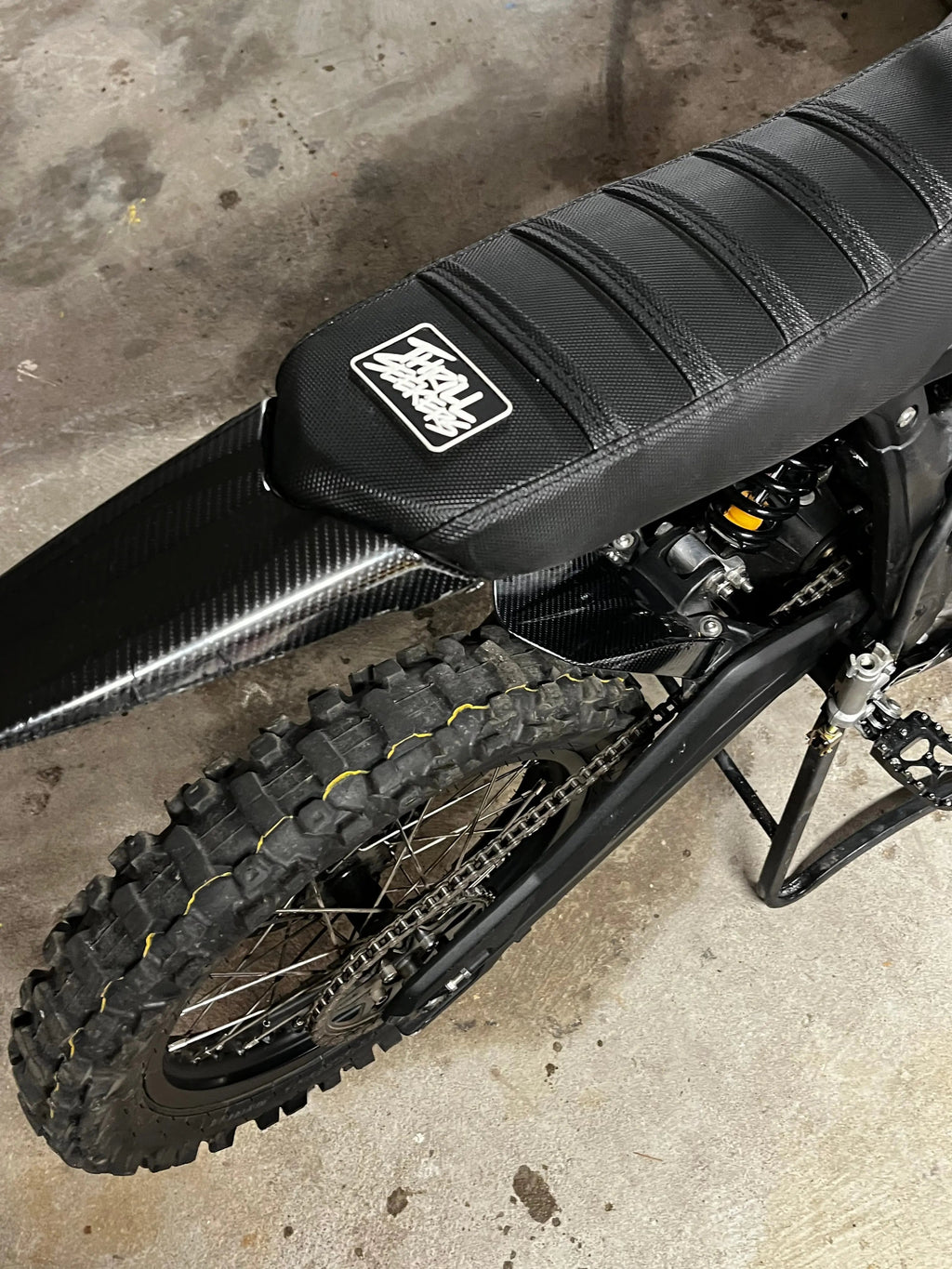 Carbon fiber vinyl wrap kit for Talaria Mx3/Mx4 bikes, featuring textured black finish from MXwraps, shown on the product.