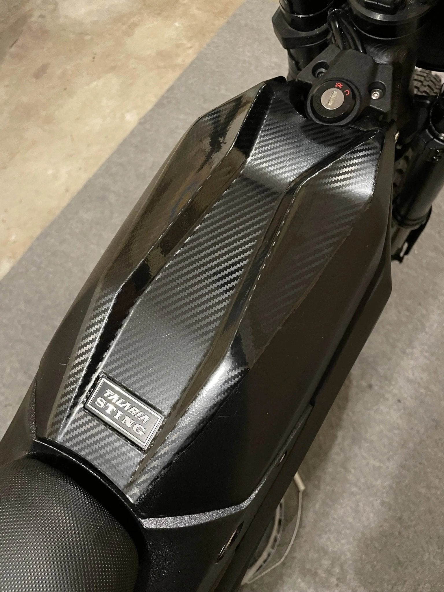 Carbon fiber vinyl wrap kit for Talaria Mx3/Mx4 bikes by MXwraps, featuring glossy black and textured carbon fiber pattern.