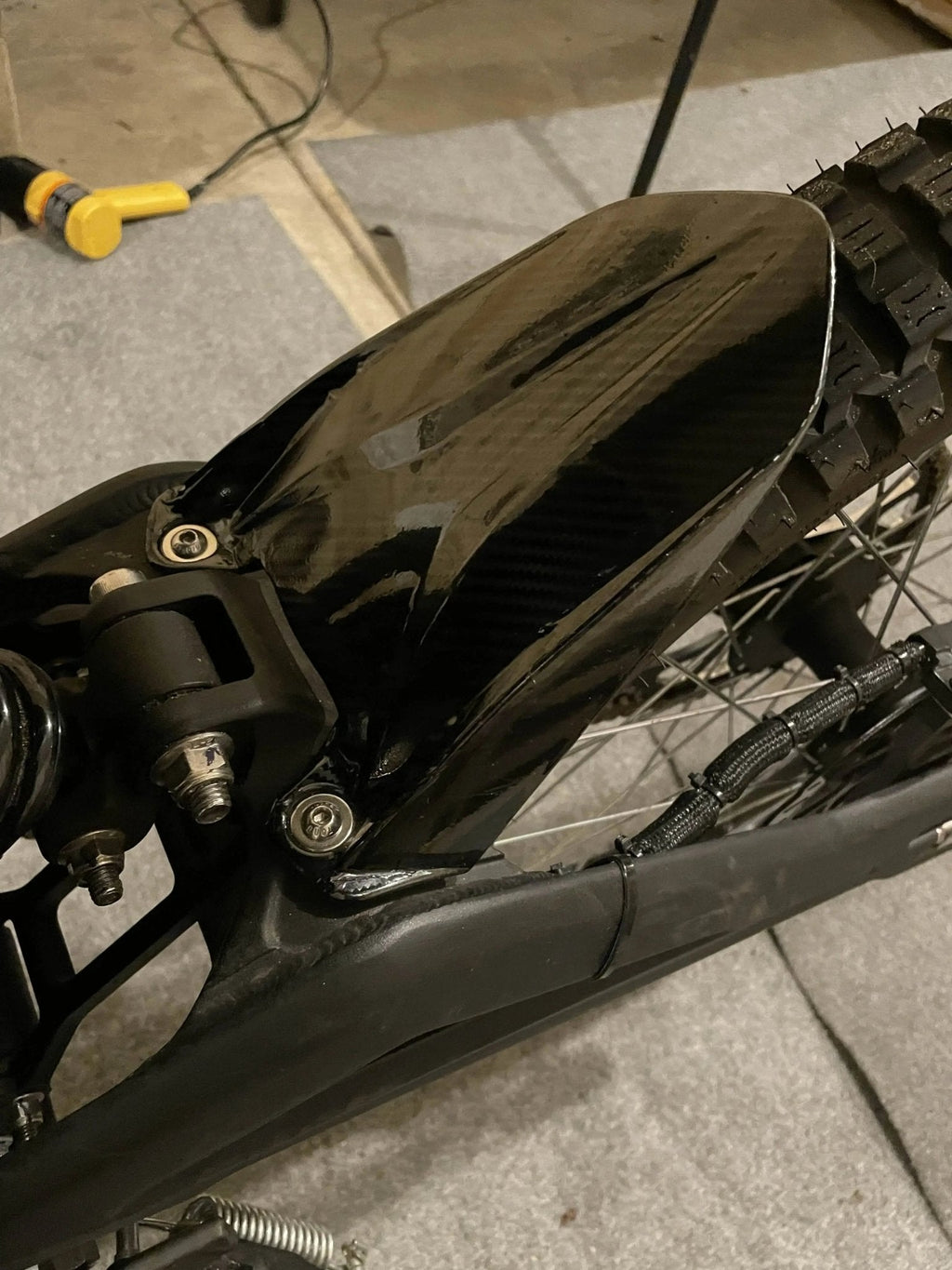 Carbon fiber vinyl wrap kit for Talaria Mx3/Mx4 by MXwraps, featuring textured black and gray carbon fiber pattern.