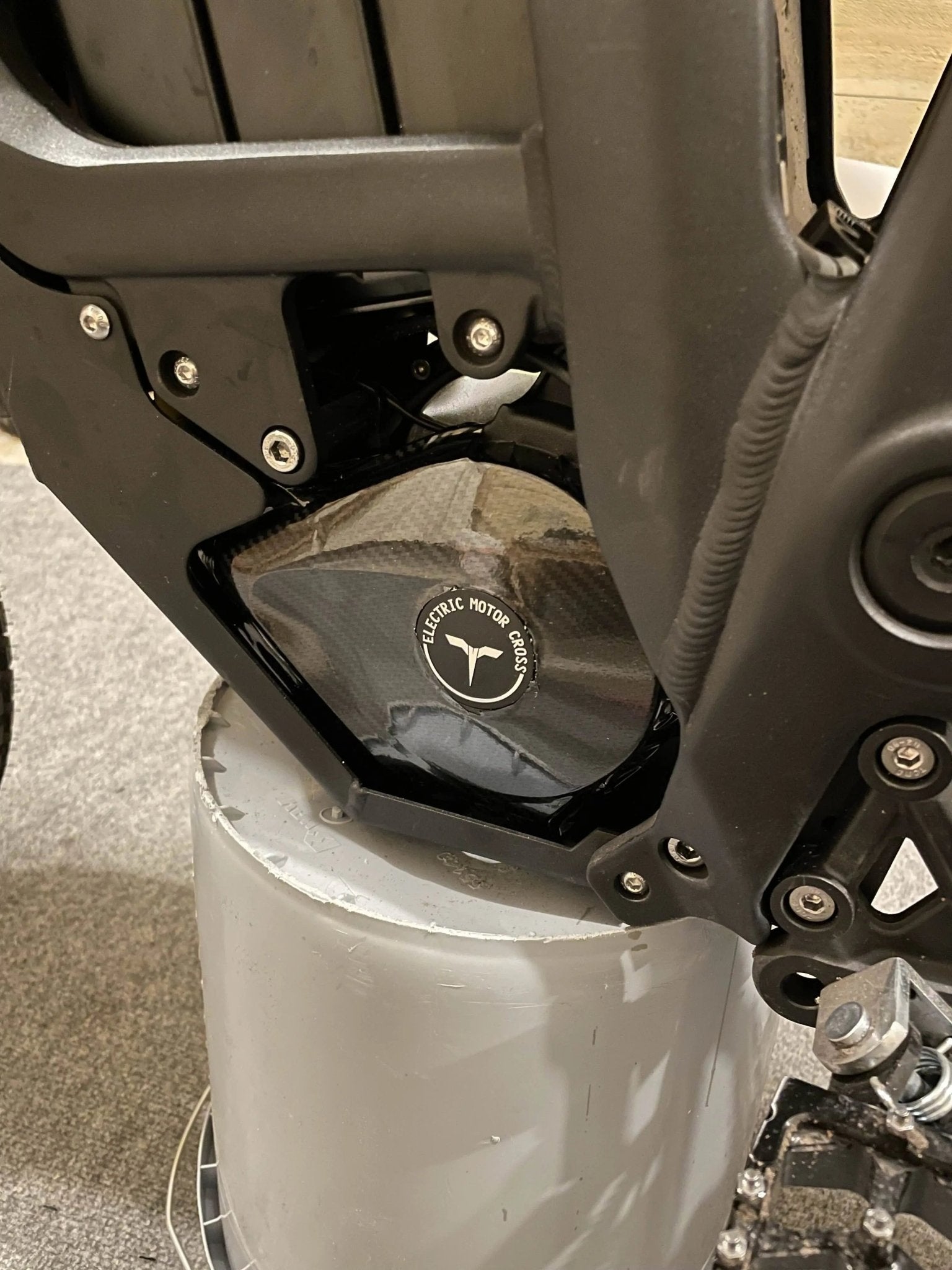 Carbon fiber vinyl wrap kit for Talaria Mx3/Mx4 by MXwraps, featuring rolls of textured black carbon fiber film.