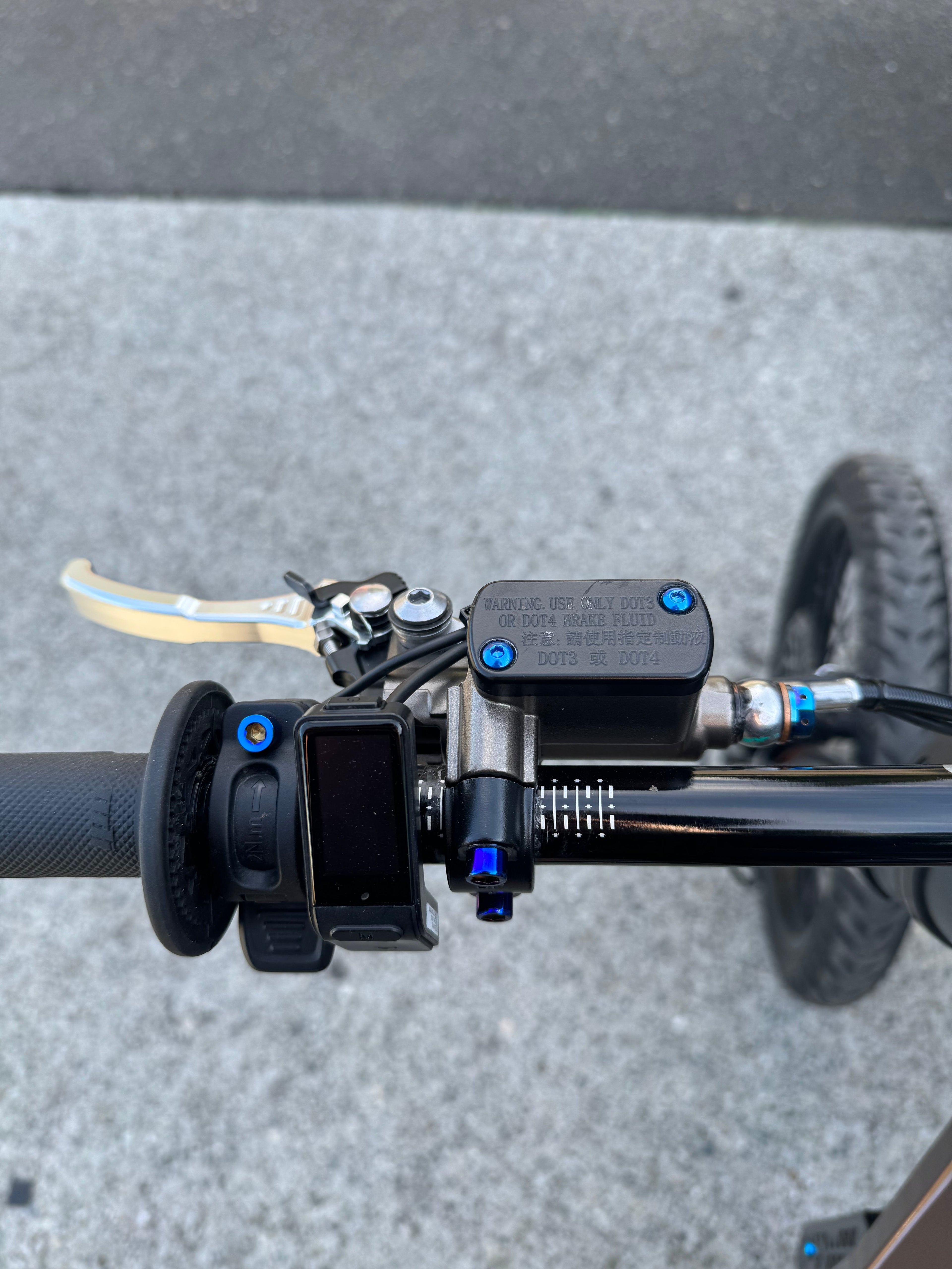 Titanium brake reservoir cap bolts by Mxp_designs, showing close-up of durable, lightweight metal fasteners on a motorcycle brake system