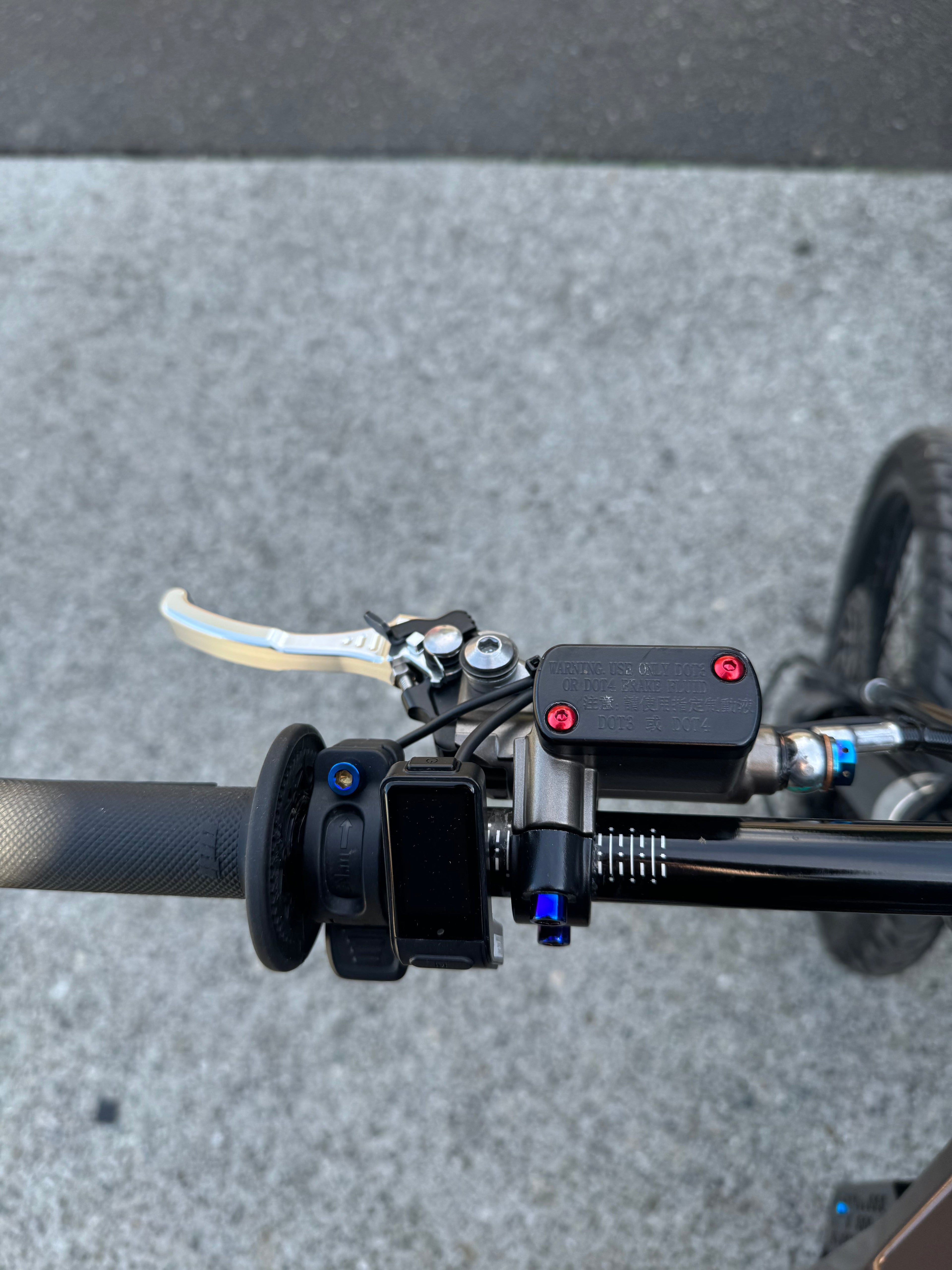 Titanium brake reservoir cap bolts by Mxp_designs, showing close-up of durable, lightweight metal fasteners for motorcycle brake system