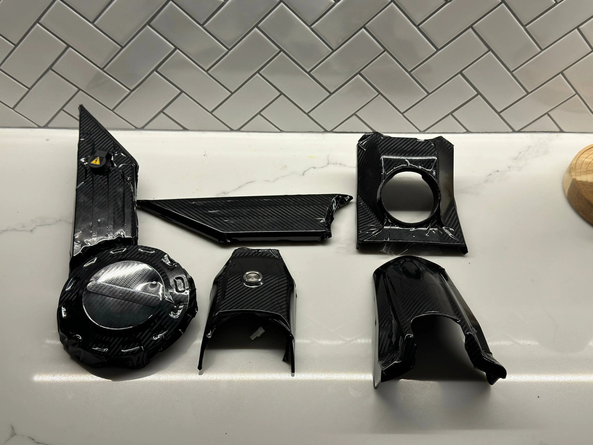 MXwraps Talaria XXX carbon fiber vinyl wrap kit showing black textured carbon fiber pattern for vehicle customization