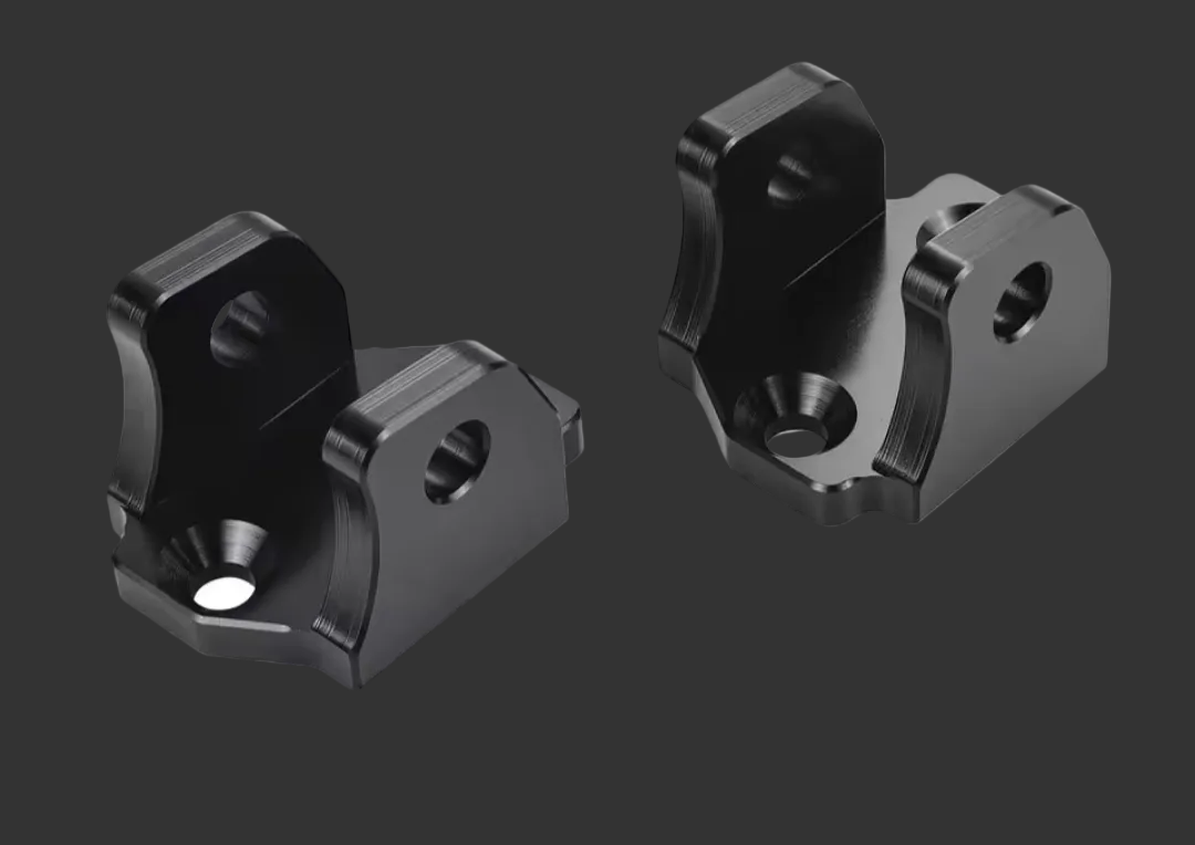 South Coast Moto Upgraded Tuttio Peg Mounts installed on motorcycle footpegs, showcasing durable, precision-engineered mounting hardware.